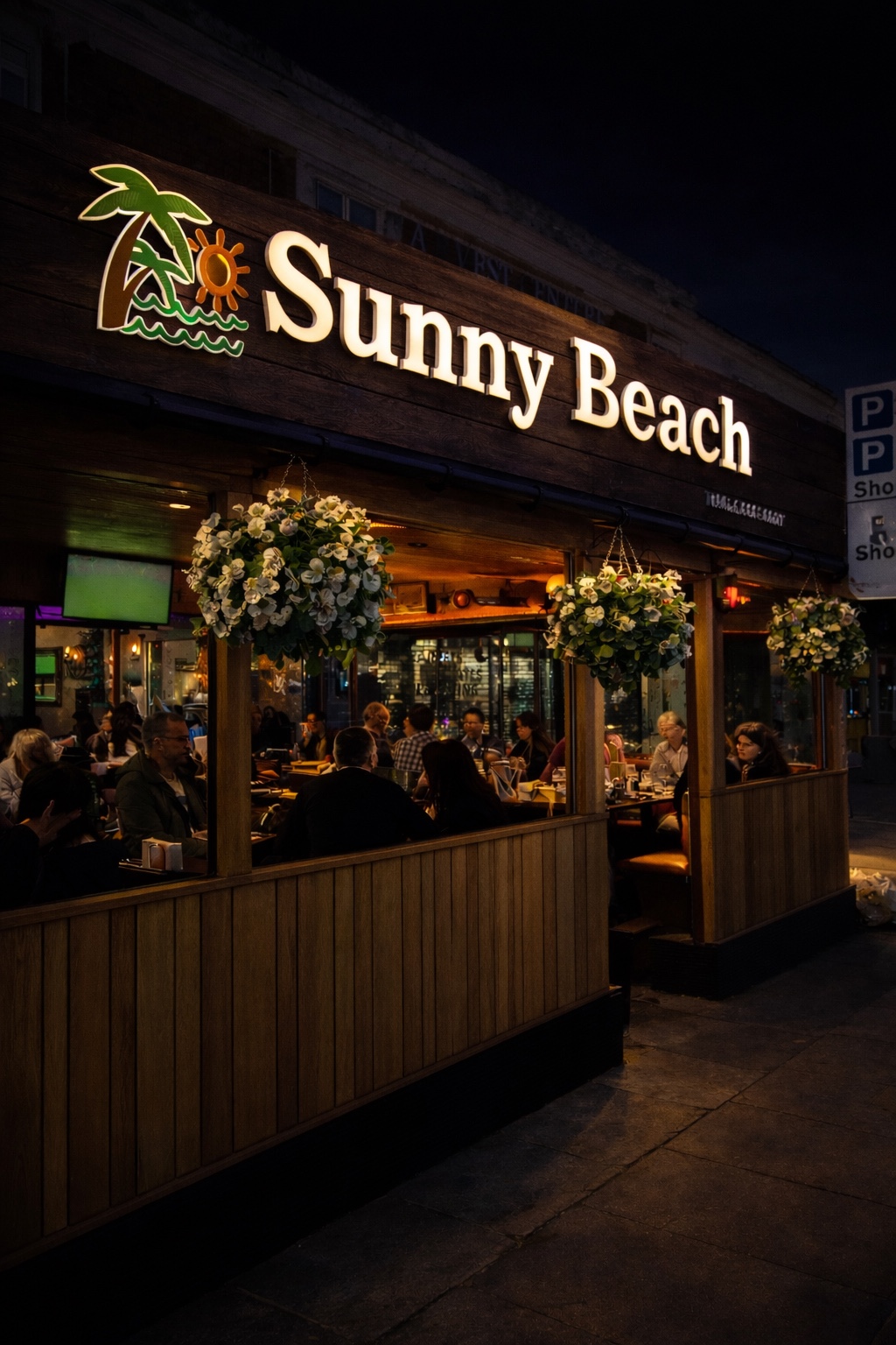 Sunny Beach Restaurant exterior and illuminated sign at night